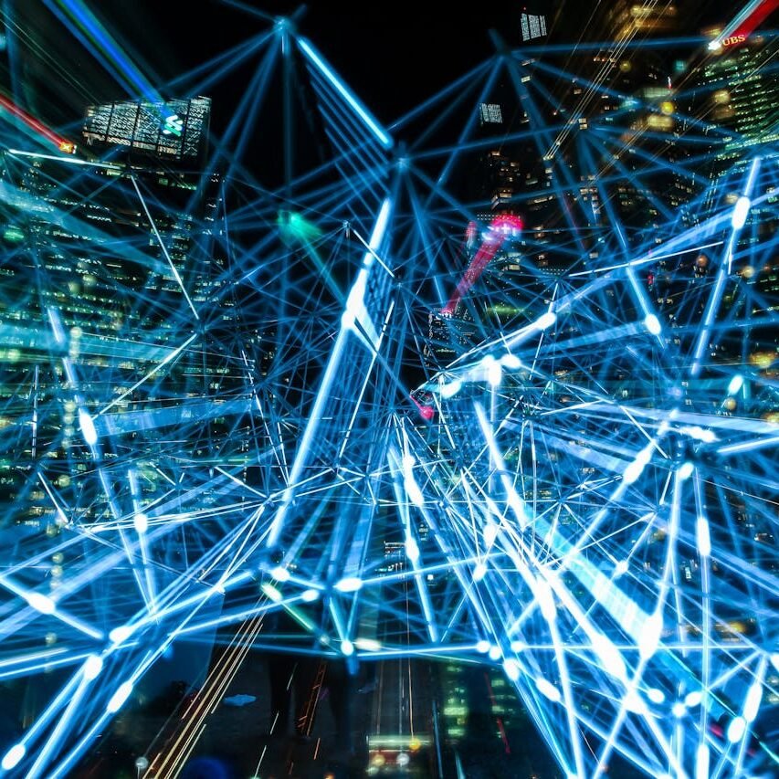 Dynamic urban scene showcasing interconnected light trails representing digital communication networks.